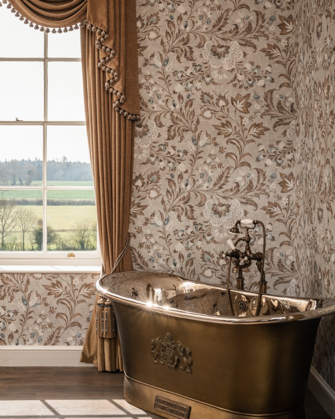 Orpheus: a dramatic, wallpapered bedroom with a bath in front of an ornate window