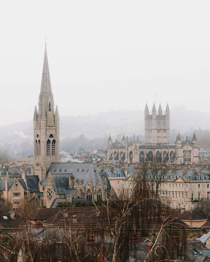 The spires of Bath's abbeys and churches rising above the city on a foggy day