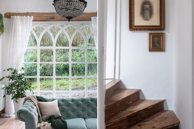On the left, a blue velvet sofa in front of a large Gothic window; on the right, a winding staircase