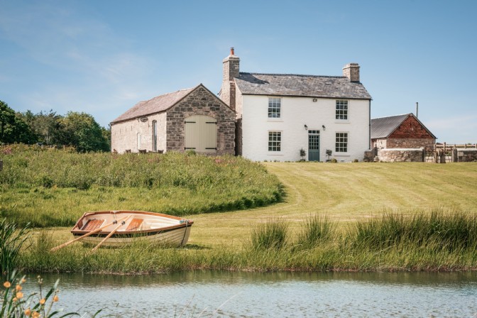 Eirianfa: a white country house with a rowboat lake