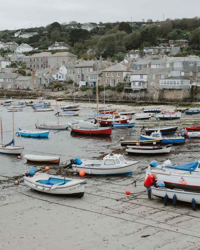 Mousehole, a Cornish coastal village, with boats in the harbour during winter