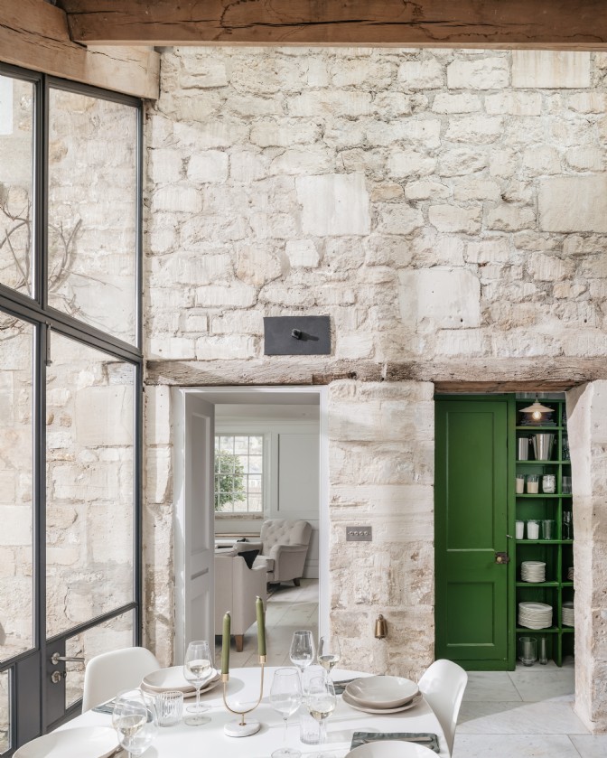 A light stone dining room with green cabinetry at Margot´s Townhouse