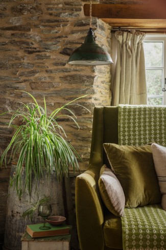 Sink into the moss-green velvet sofa