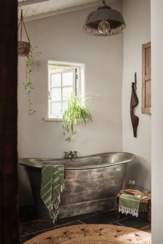 A large, free-standing bathtub awaits leisurely soaks