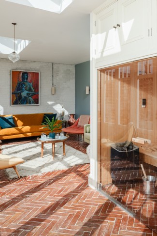 A spacious wellness area features a sauna, showers and relaxation space