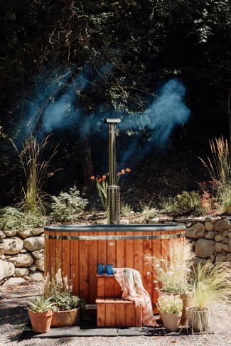 Sinking into the wood fired hot tub can help relax muscles and alleviate stress