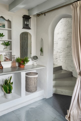 Descend the steps to the bathroom on the lower floor