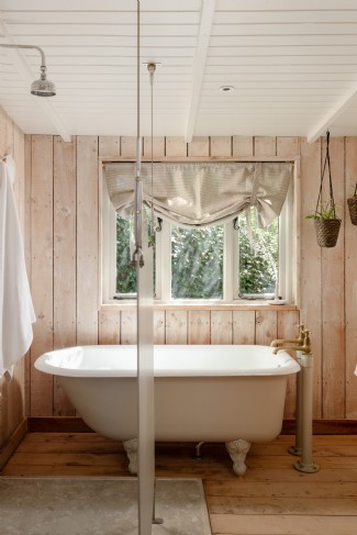 The bathroom features a claw-foot tub and double shower