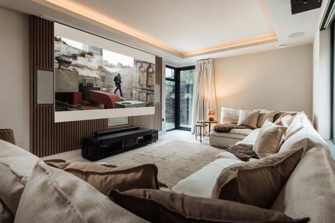 The cinema features a television and large projection screen with surround sound