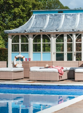 Summer days were made for reclining by the pool house